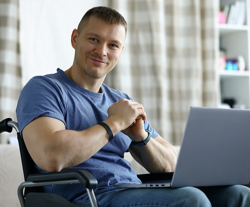 Man using a laptop representing how FAAST can assist individuals with disabilities in obtaining affordable home loans to modify a home to fit their specific needs