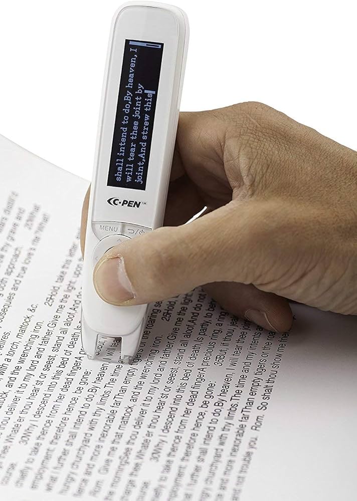 A Hand holding a White handheld device over text in a book