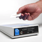 A small rectangular box with a hand hovering a small card over it
