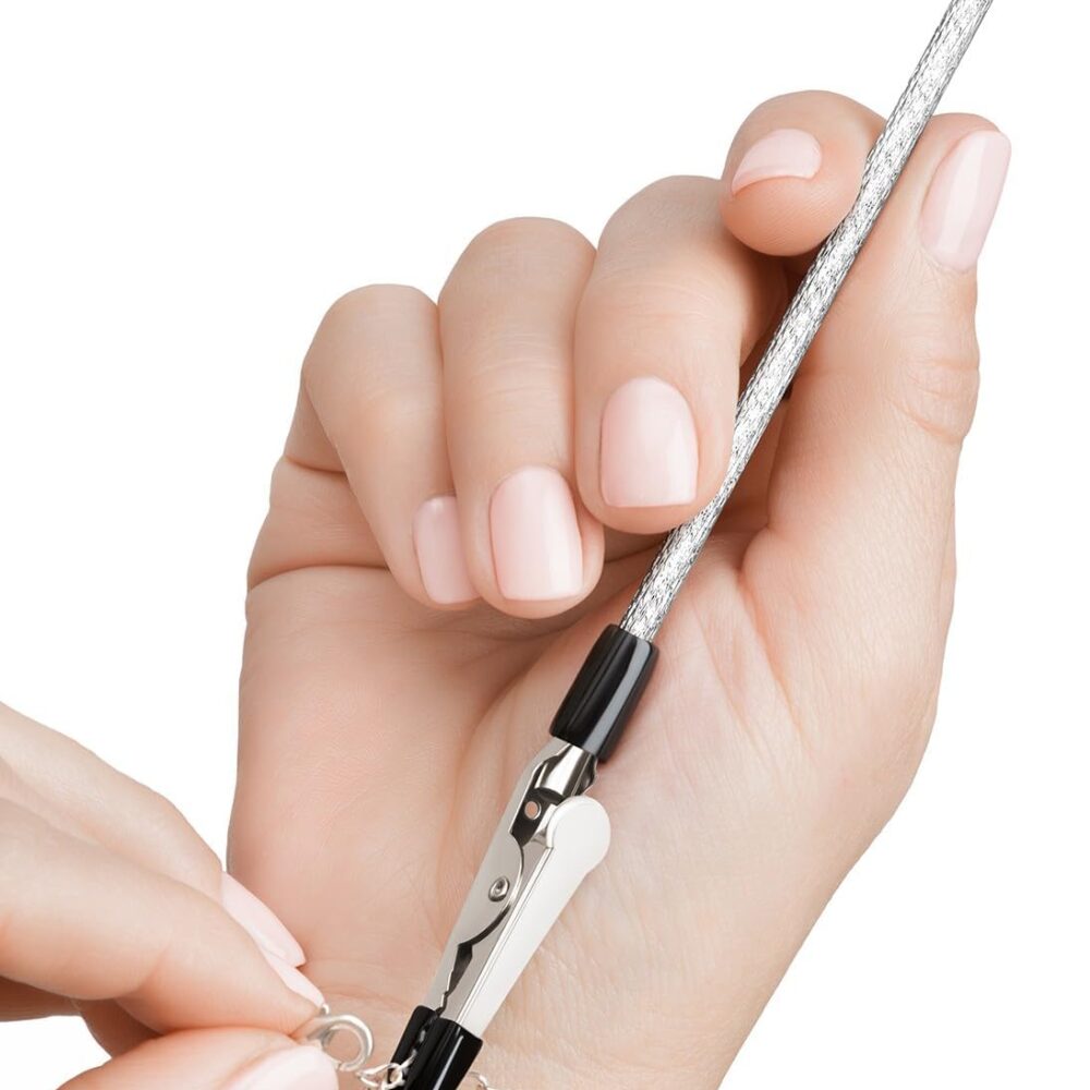Pencil sized metal tool with clasp to hold bracelet in place